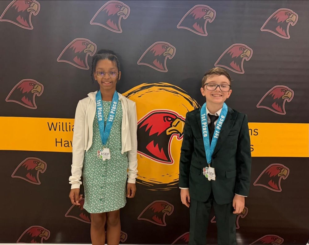 Ella and Donald posing with their 1st place medals from the state science fair.