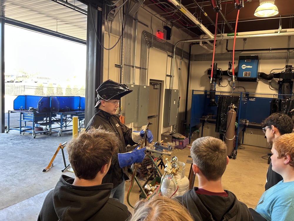 Our students watching a high school student explaining welding at the Huntsville City School Center for Technology