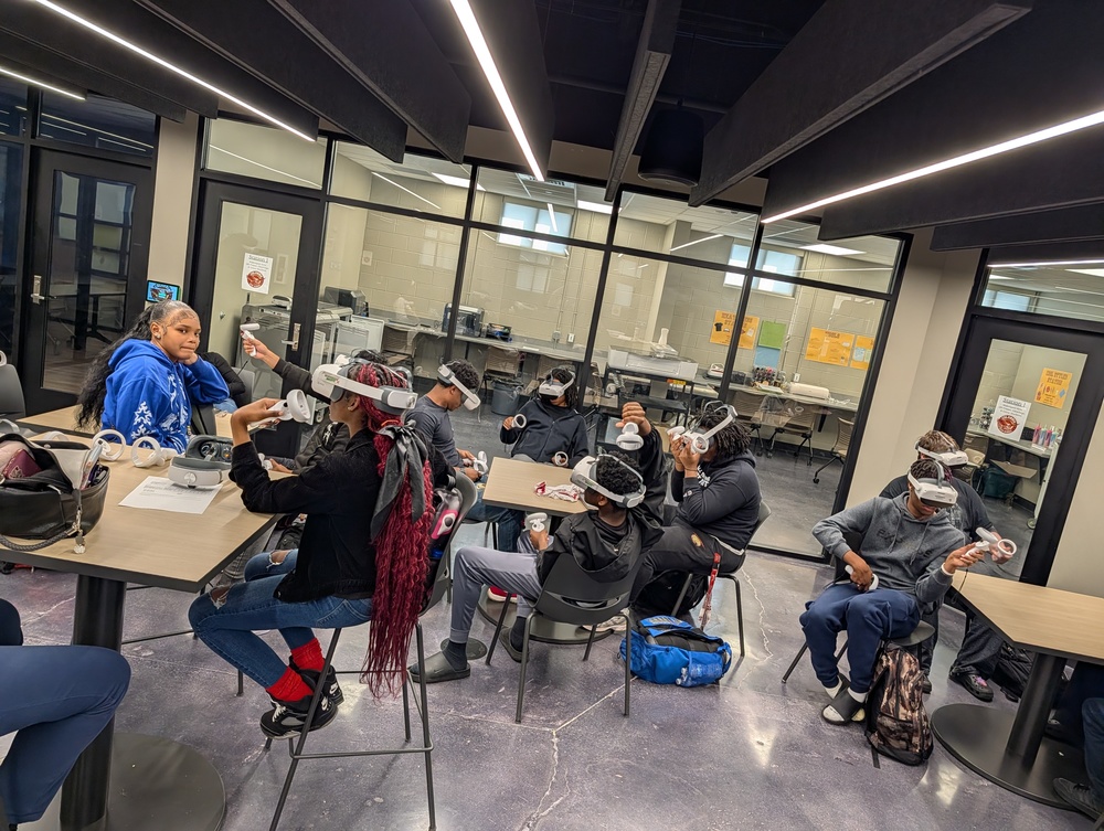Students in Chemistry class sitting at tables using Virtual Reality Headsets in the Innovation Center