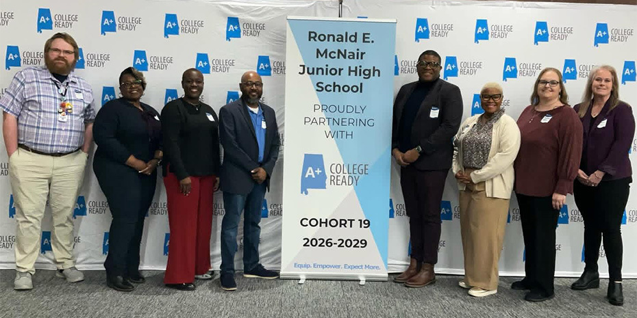 McNair Junior High staff pose alongside district staff next to an announcement banner for the A+ College Ready Cohort 19 2026-2029