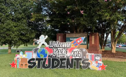 Welcome back students sign on school front lawn