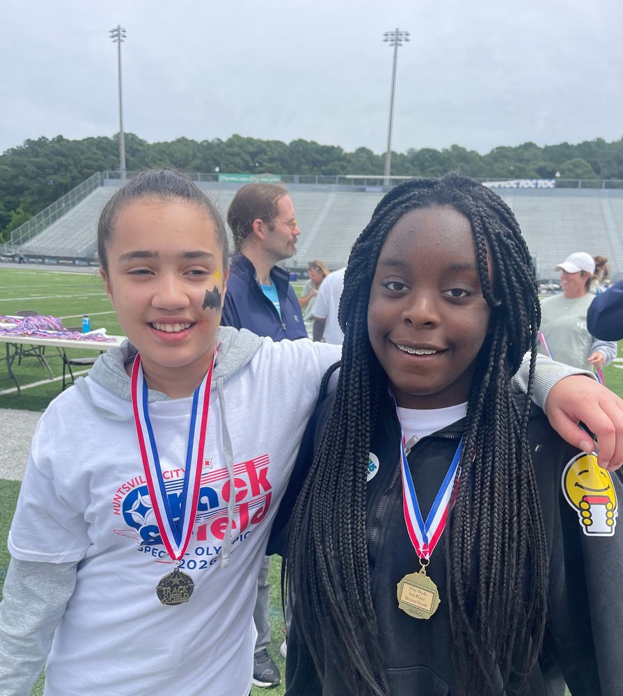 Lela and Aaliyah at the special olympics with their medals after getting third in the 50 m run. 