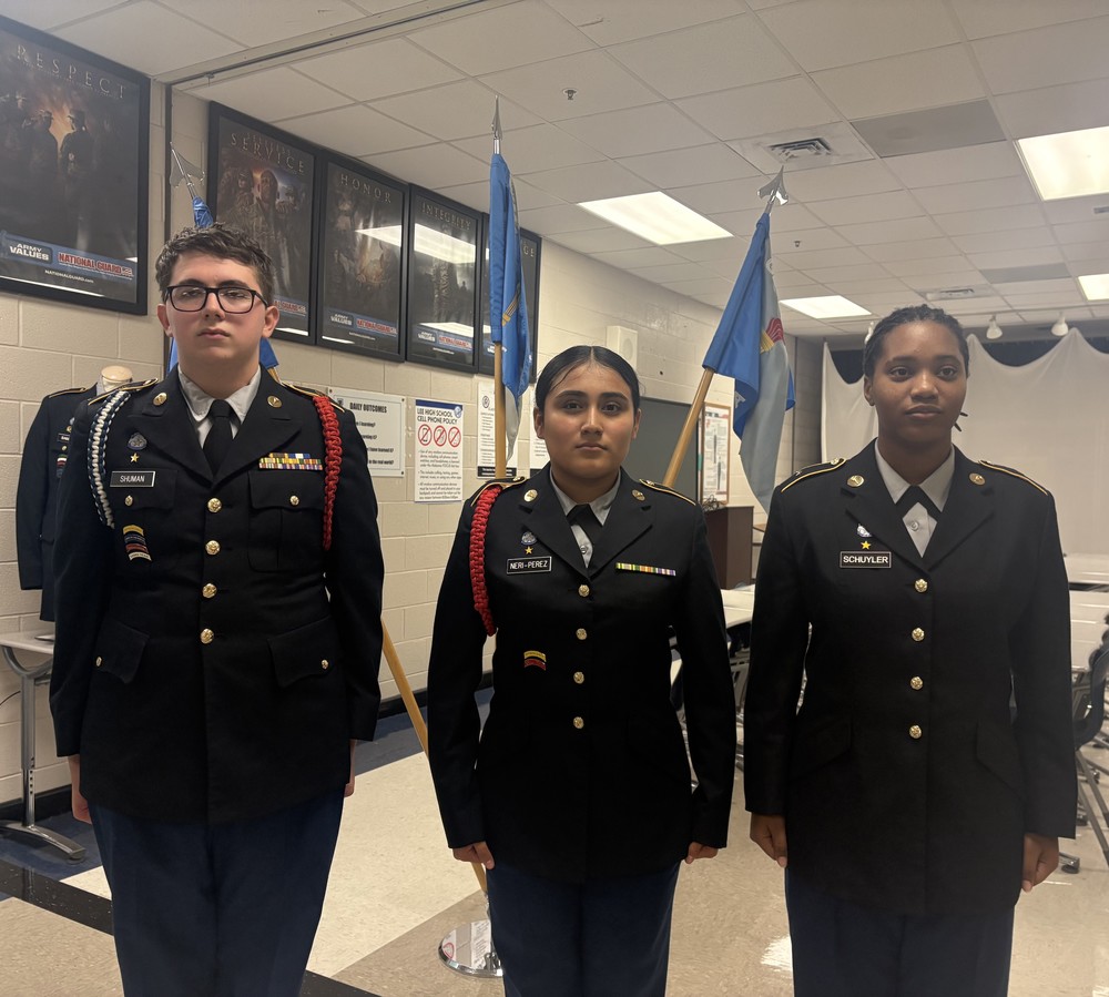 The students who were promoted this month stand at attention in their JROTC uniforms.