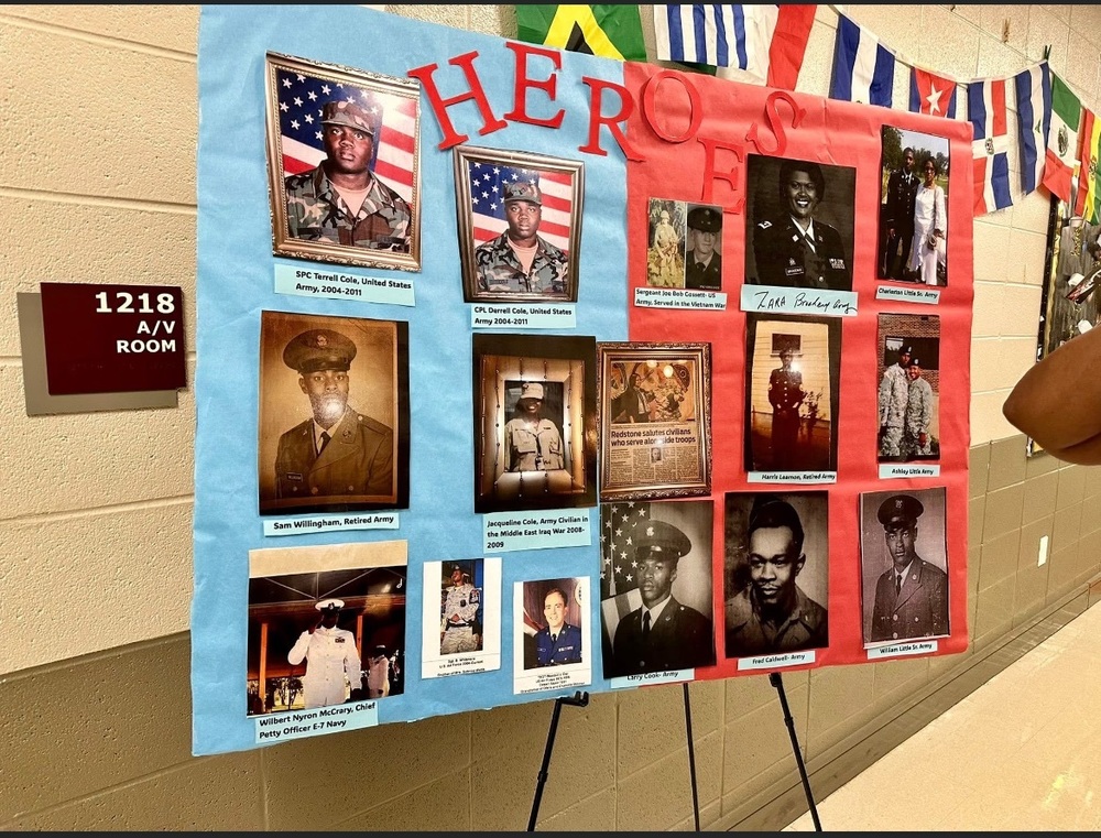 A large poster in the Morris Elementary hallway with pictures of the students family members who are veterans