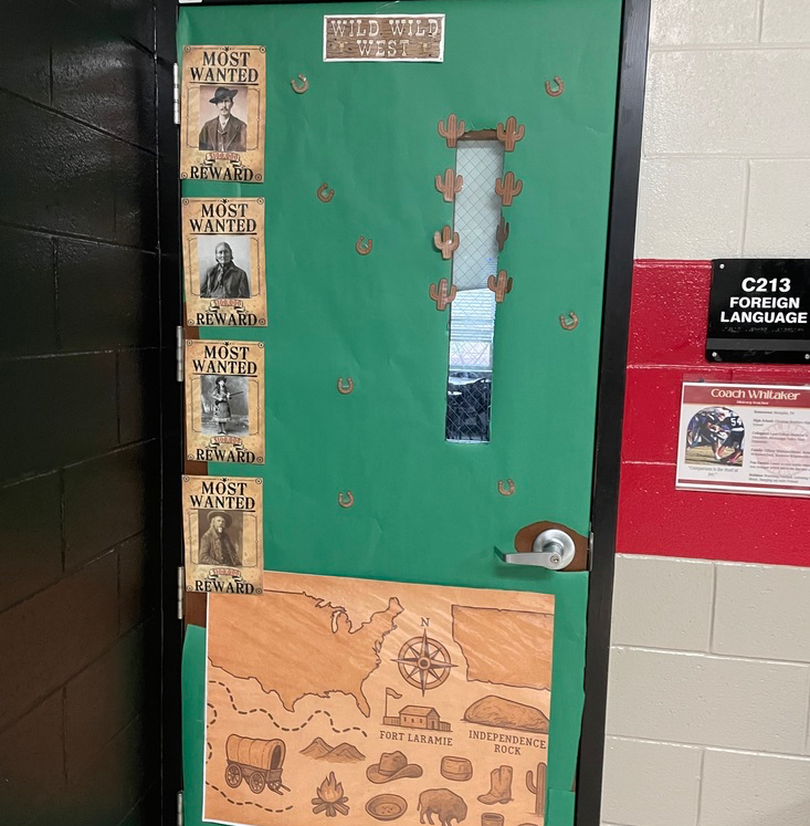 Door in green brown with wanted posters of historical figures 
