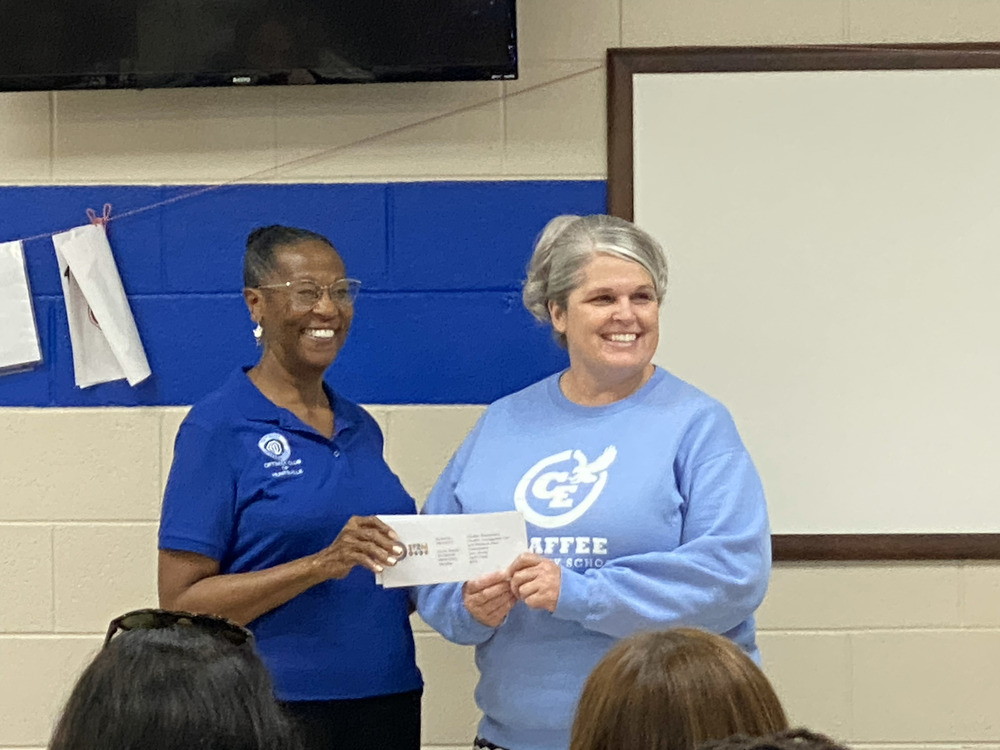 Chaffee principal accepting grant check from Optimist Club