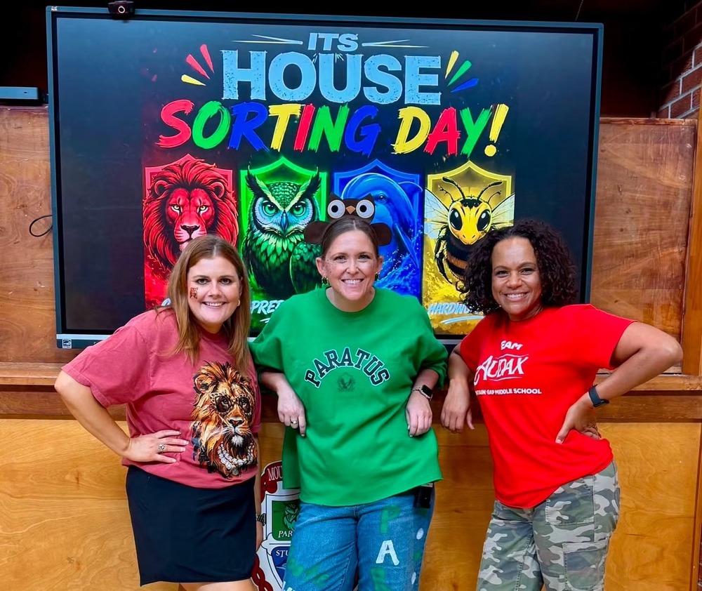MGMS administrative team poses for a picture decked out in their House spirit wear