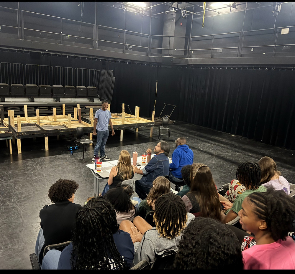 Senior student Christian Bailey performs his Trumbauer acting piece on stage in Lee High School’s black box theatre while a panel of judges provides feedback. Behind the judges, theatre students watch attentively, waiting for their turn to present during the pre-trial juries.