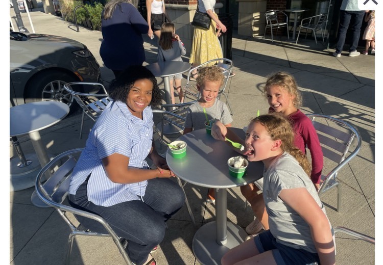 Ms. Warren and three children eating yogurt
