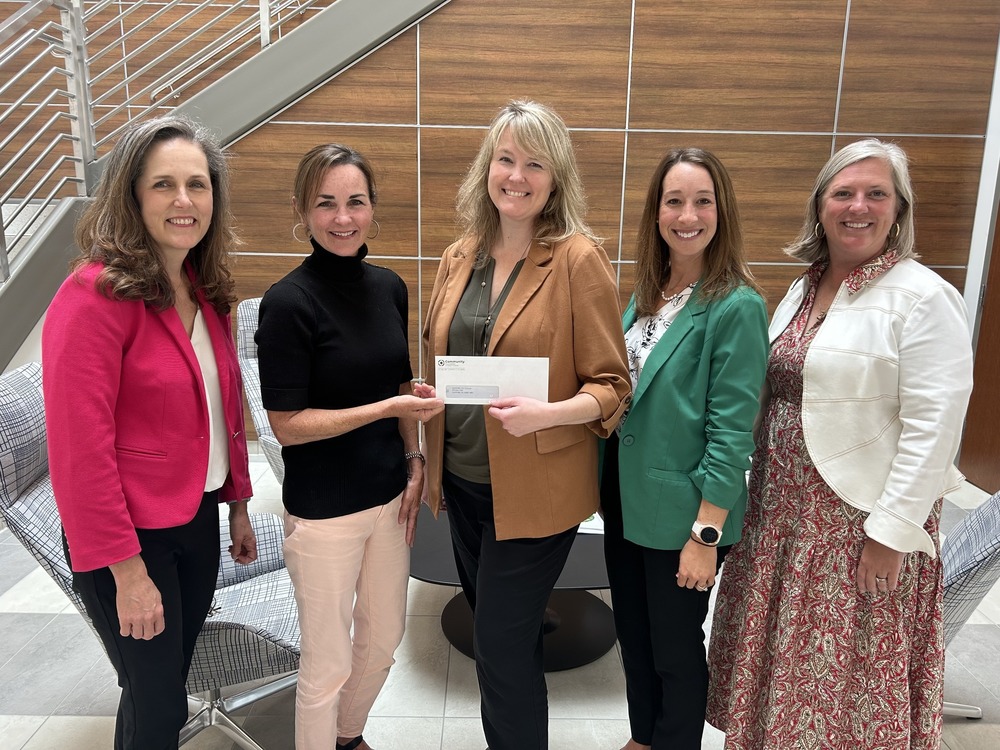 HCS representatives accept grant check from Google Fiber representative