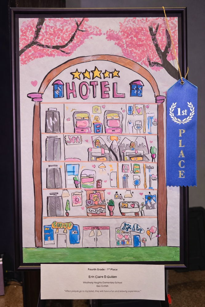 A colorful drawing of a multi-story hotel with "HOTEL" written at the top and a blue "1st Place" ribbon on the side.