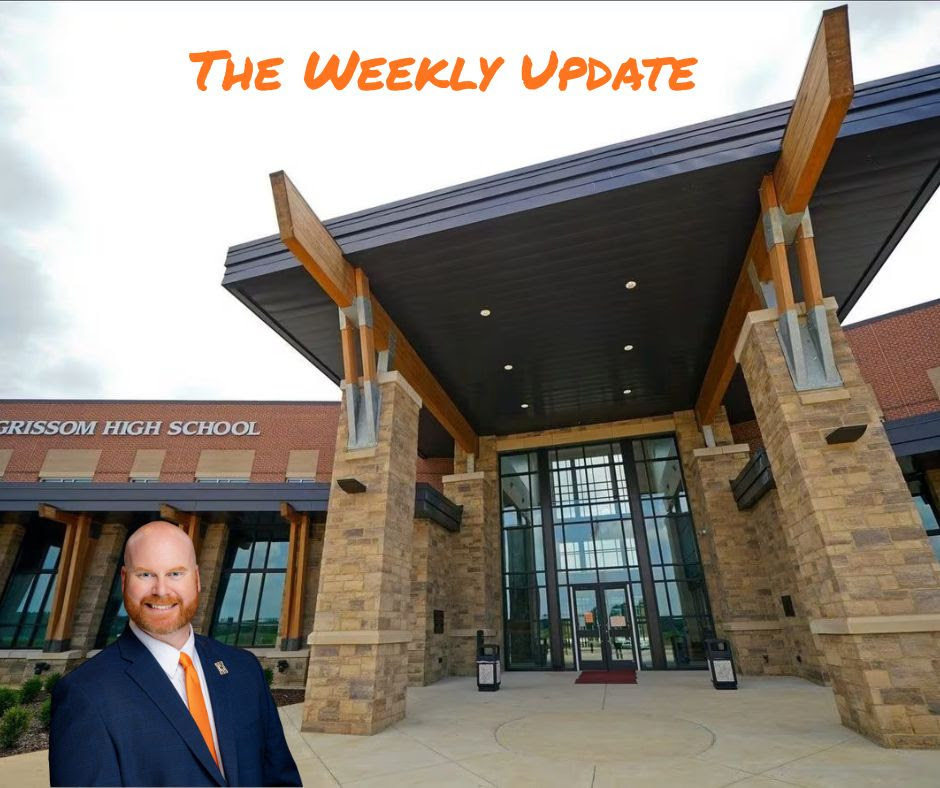 Grissom Highschool with the words "The Weekly Update". The principal David Coker is Standing in front of the school