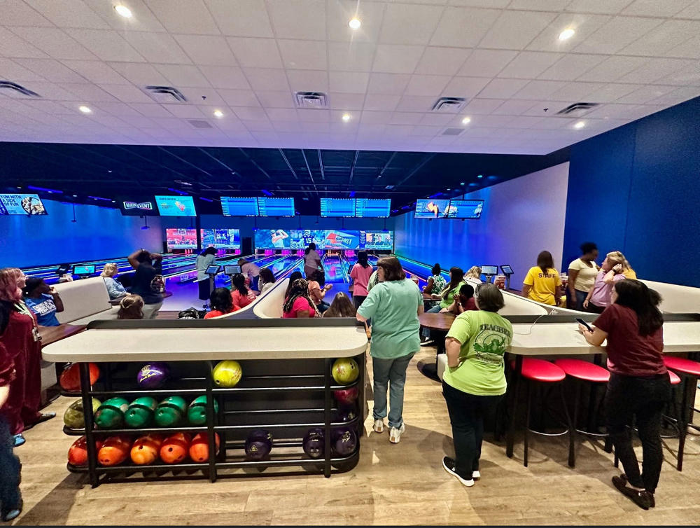 teachers standing in line waiting to bowl with their teams