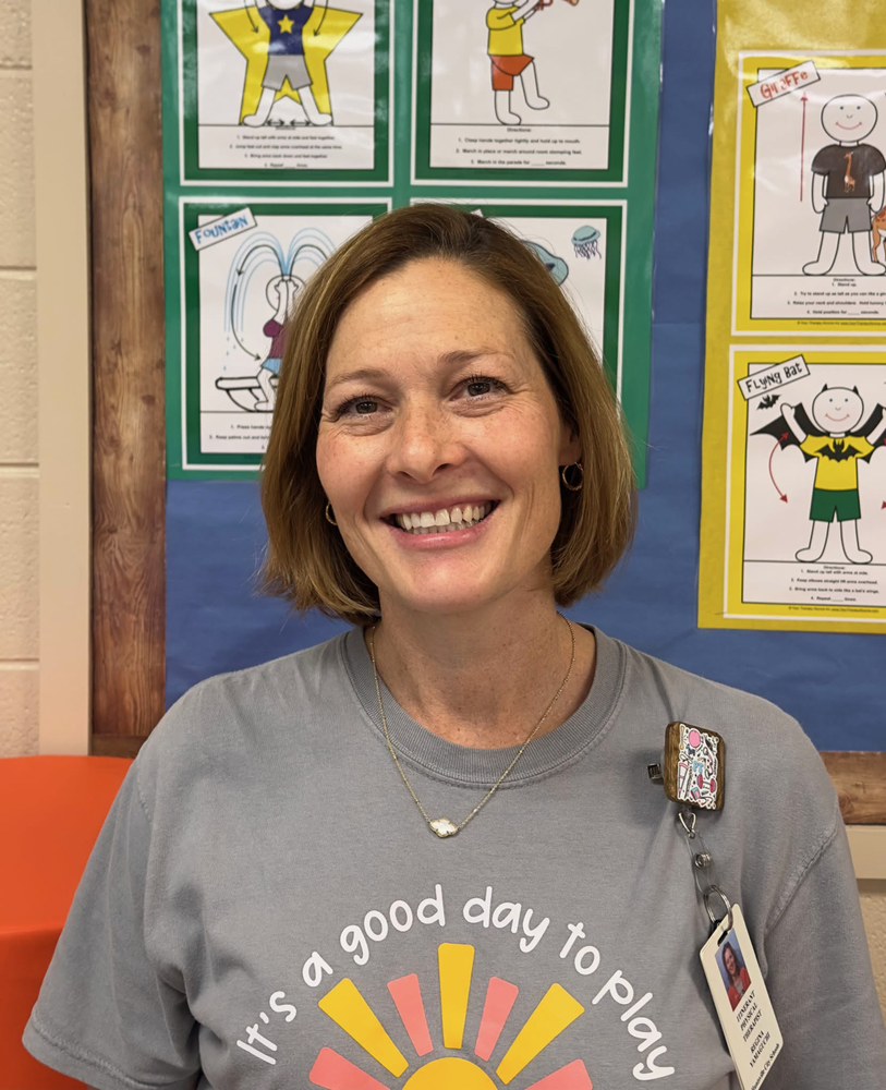 Headshot of Mrs. Yamaguchi in front of a bulletin board.