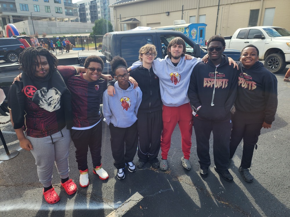 7 Esports members with some dressed in different esports shirts some in black and red and others in light gray 