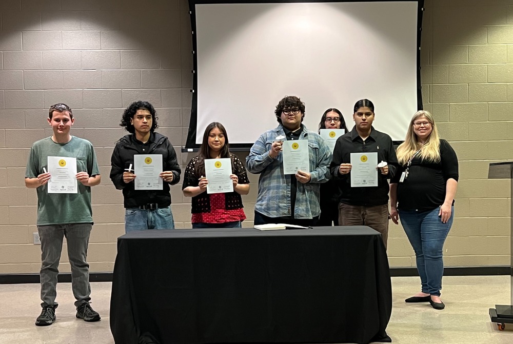 Inductees pose with Ms. Fyda and their honor society certificates.