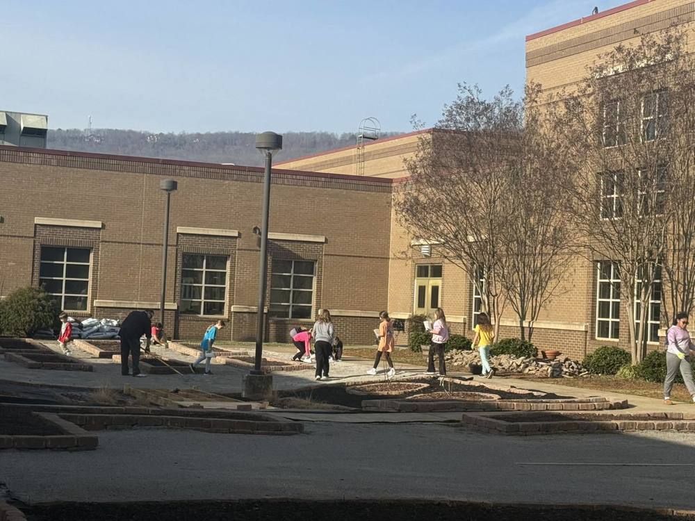 Fourth grade students working in outdoor classroom of GSES courtyard