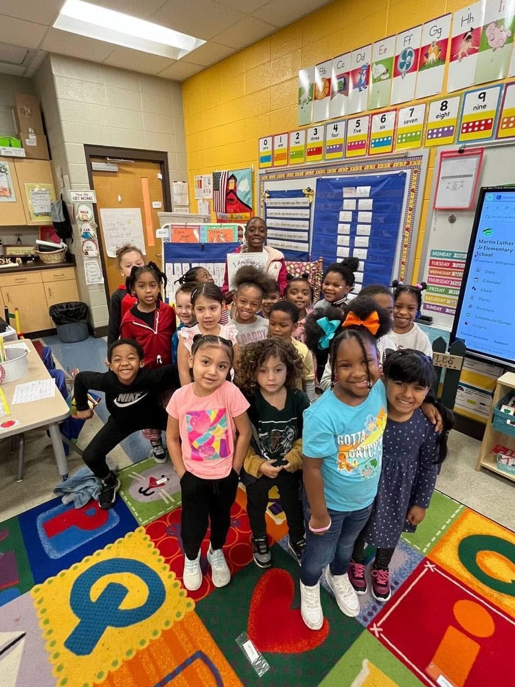 Girls with PEARLS standing with Kindergarten class after reading