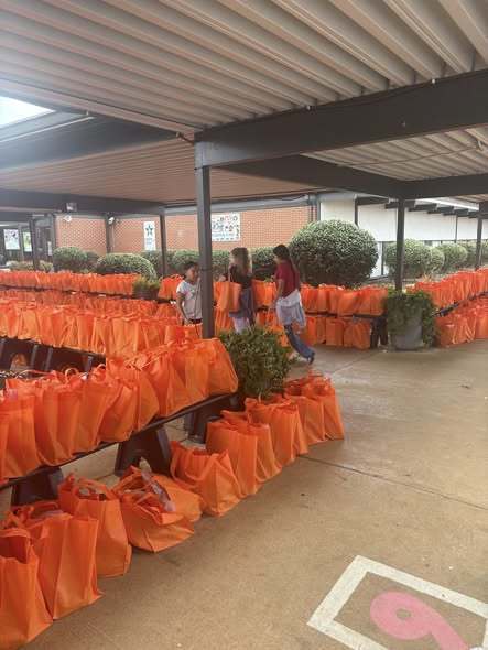 The front of the school lined with orange bags from Mayfair Church of Christ