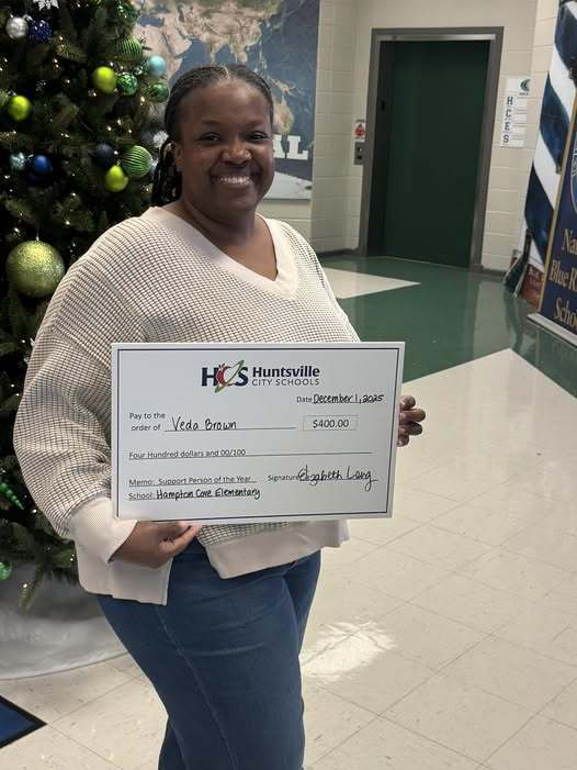 Ms. Veda holding a check for $400.00