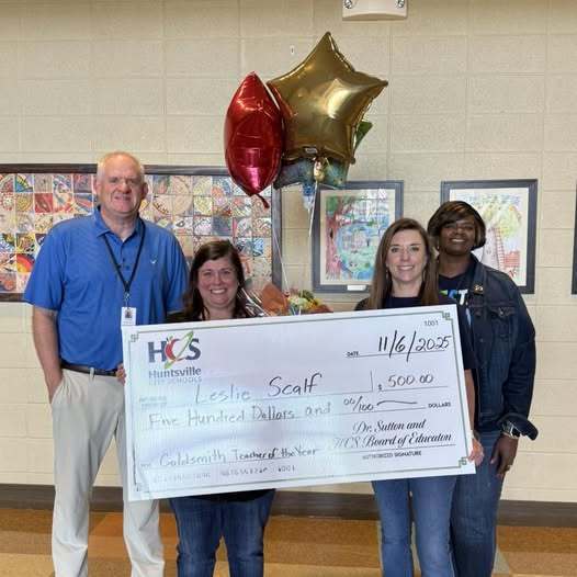 Mr. Dodds on far left, Ms. Scalf second from left, Ms. James third from left, Ms. Ford far right, stand with a 500 check for Ms. Scalf