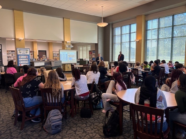 Dr. Brown speaking to AGT 8th graders in the library about College Academy.