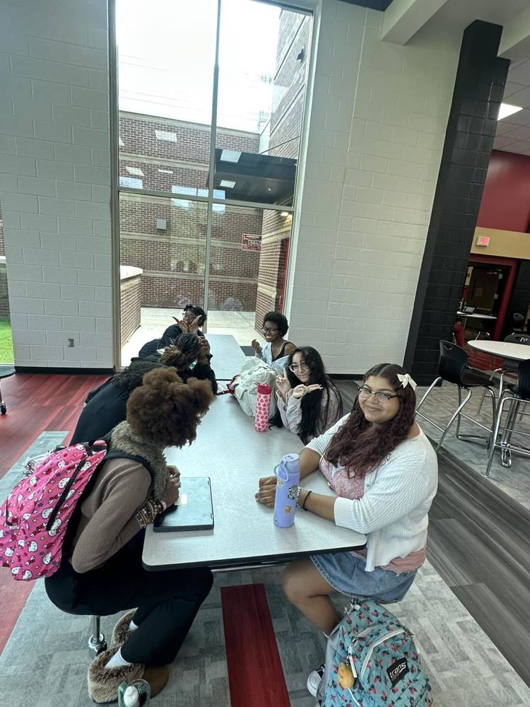 Students sitting at a table in the cafeteria during the Perfect Attendance Celebration