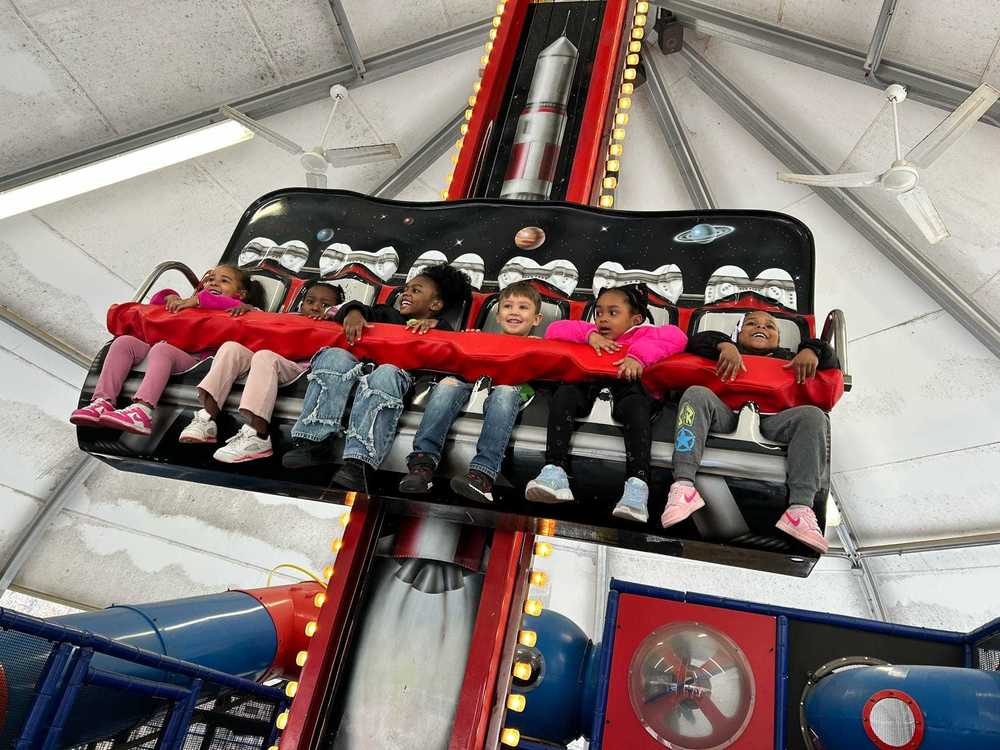 Pre-K students ride an indoor space-themed ride at the U.S. Space & Rocket Center during their field trip.