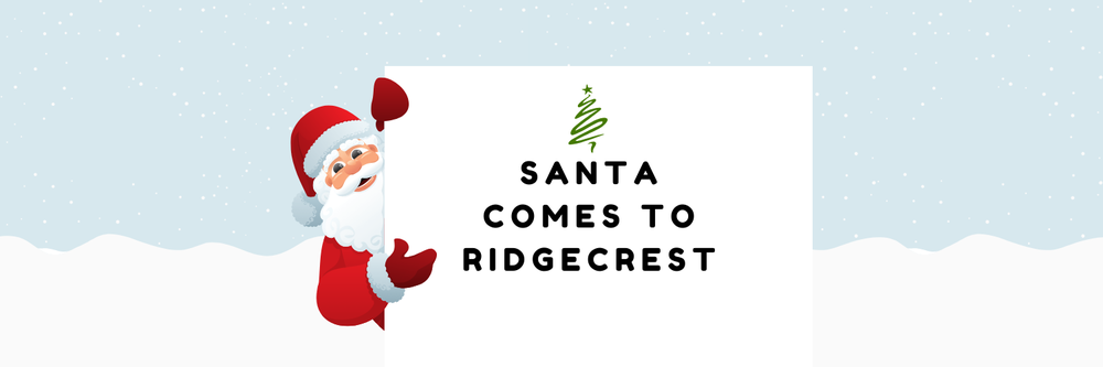 Santa holding a sign with a Christmas tree that says Santa Comes to Ridgecrest