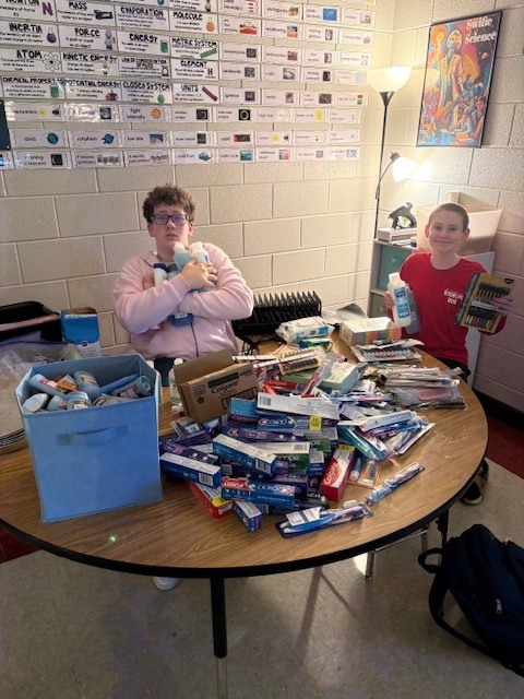 Two SGA members with the products collected during the hygiene drive.