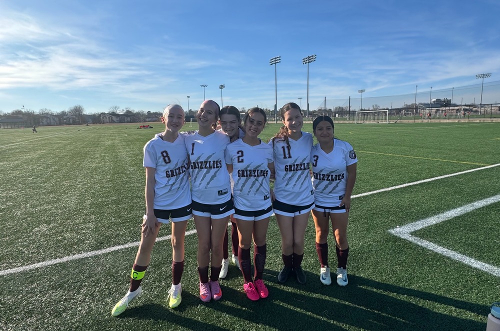 A group of mountain gap girl soccer players posing for a picture