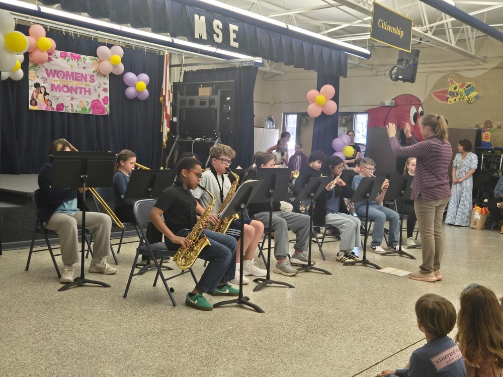 students sitting in chairs with band instruments