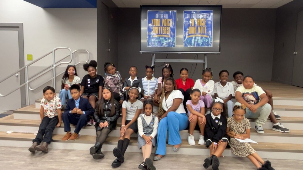 SGA sponsor and members pose sitting on a stage
