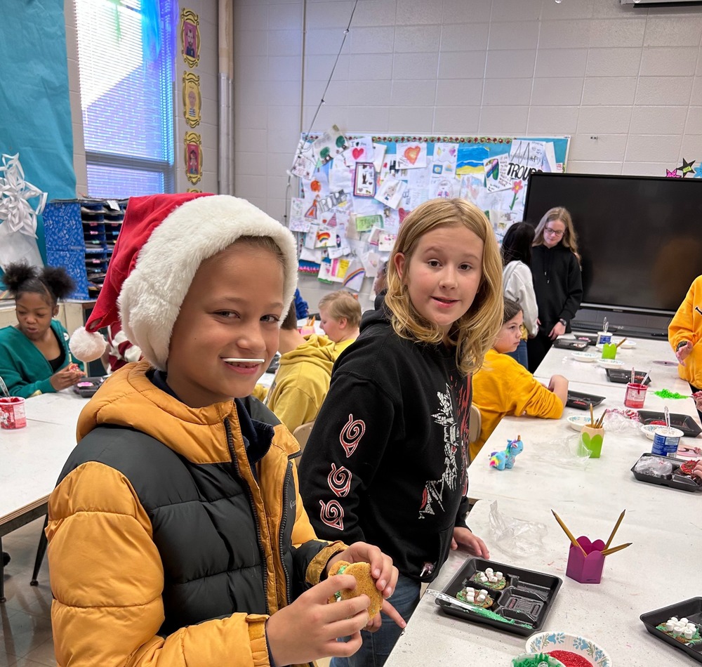 Two students decorating cookies