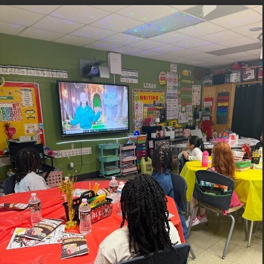 Ms. Ford's class watching clip of new House System implementation 
