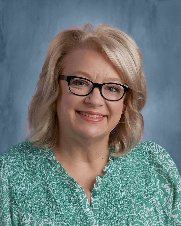 Mrs. Melillo wearing glasses and a green shirt.