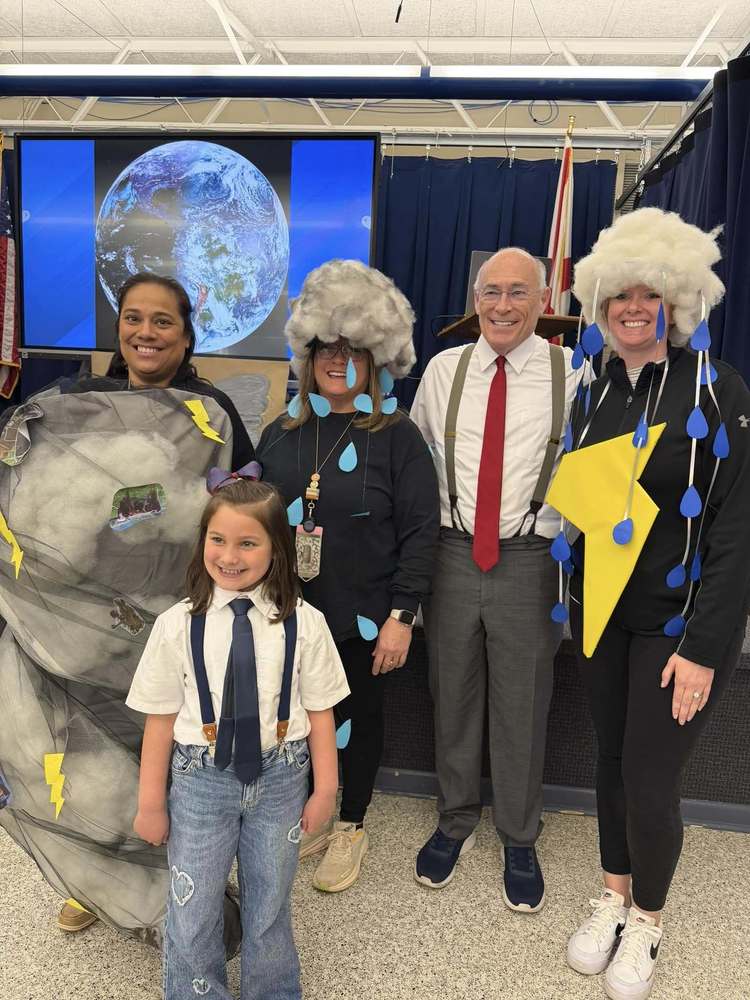 James Spann standing with teachers dressed up like storms and a student dressed like him