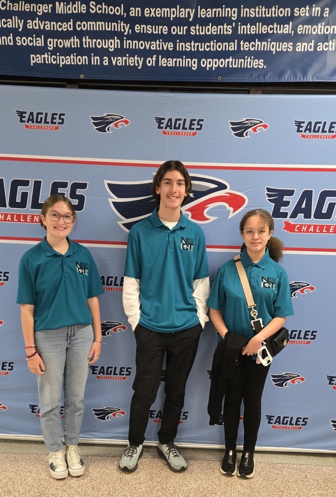 3 NCTHS students pose for a photo at Challenger Middle School