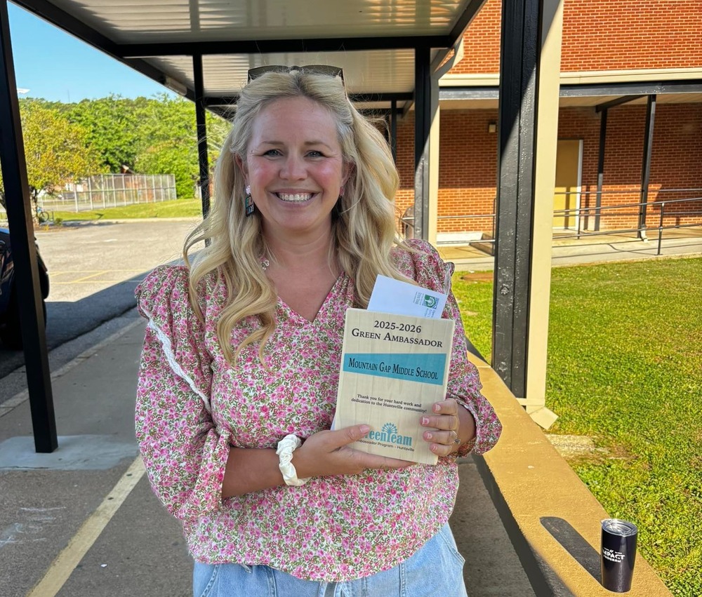 Mrs. Colley holding her certificate for being a green ambassador