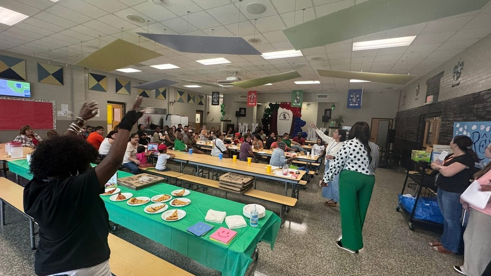 Various parents along with parent coordinator(in black shirt) gathered in school cafeteria for parent party