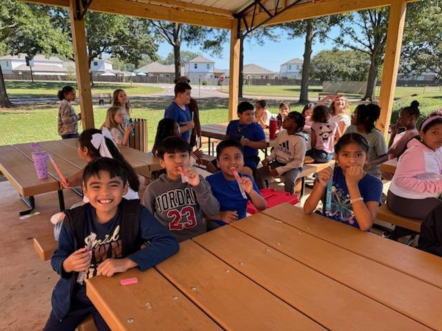 Students eating popsicles outside.