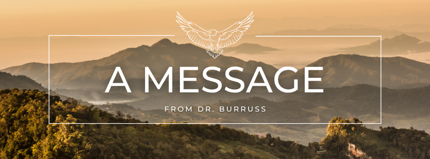 Background features misty mountain in begies and greens. The forground features a thin white rectangular outline with the line art of an eagle at the top. Inside the rectangle are the words "A message from Dr. Burruss".