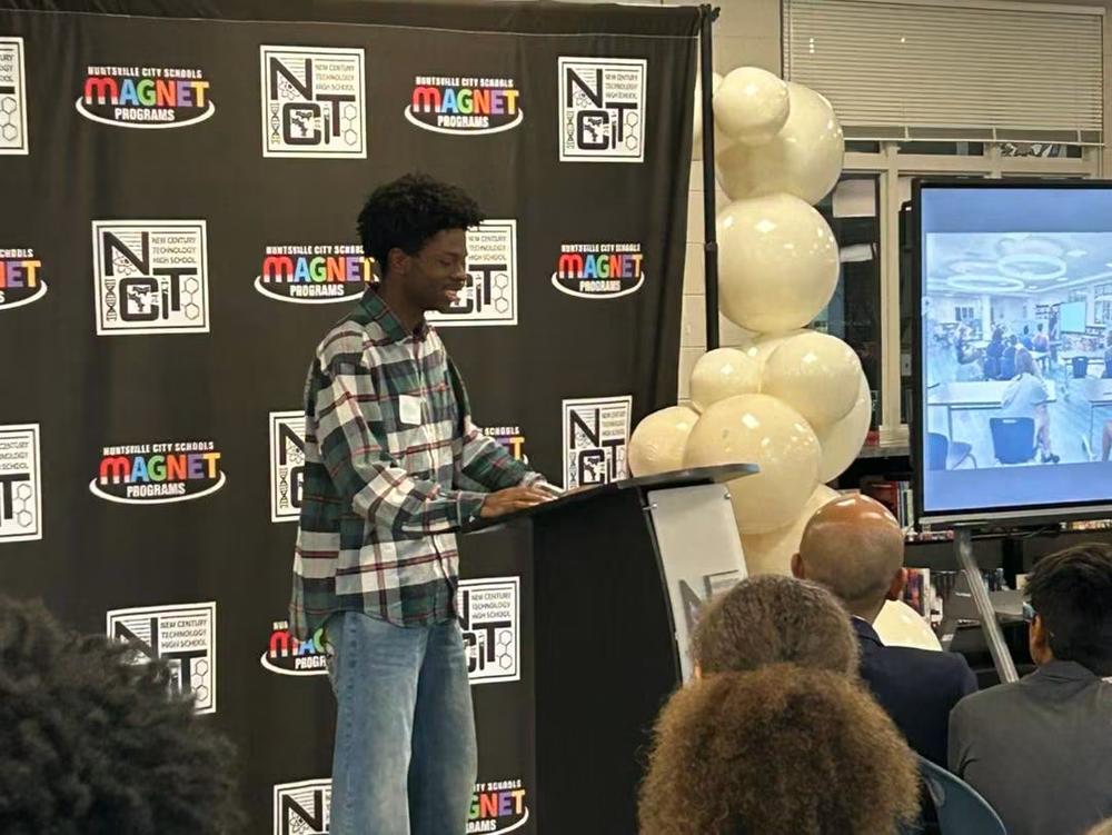 A student presents information about NCTHS to community members.