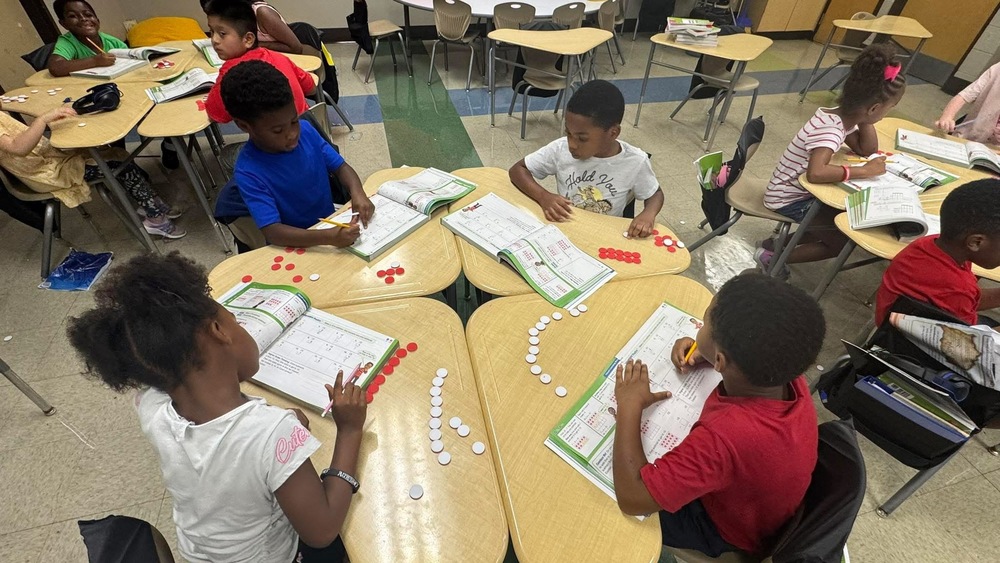 Some students in 2nd grade working in math books