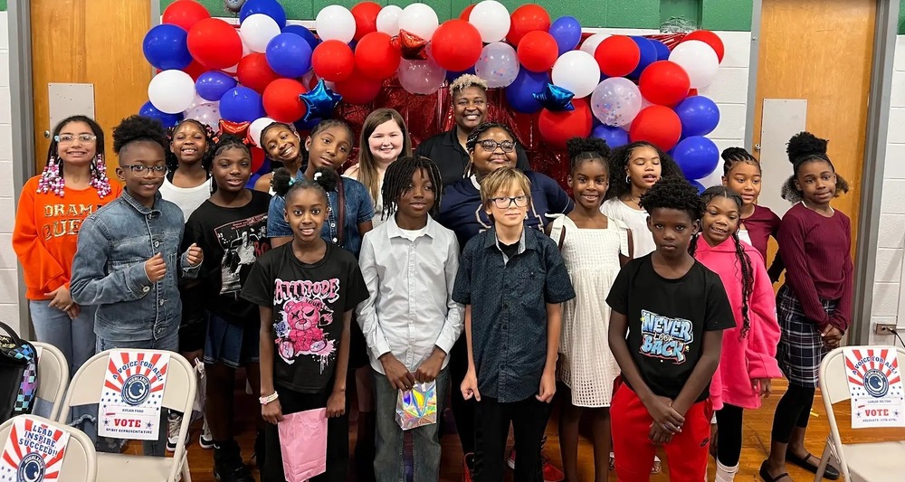 A group of students smiling and celebrating together after winning the school election