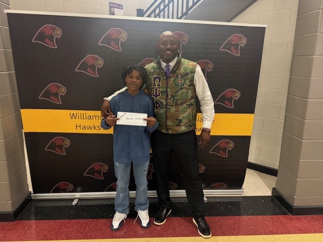 Spelling Bee winner Arrian Collins with Mr. Shipman.