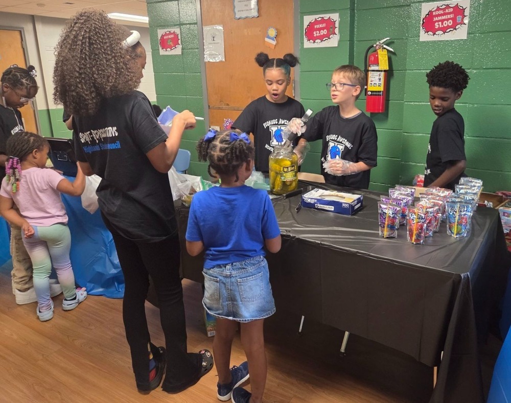 Highlands Student Council members running their candy shop fundraiser, helping students with sweet treats and smiles