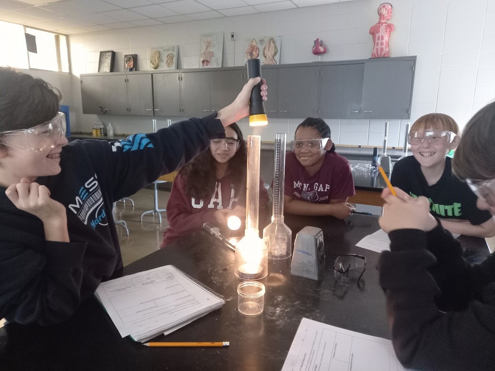 6th graders around a lab table