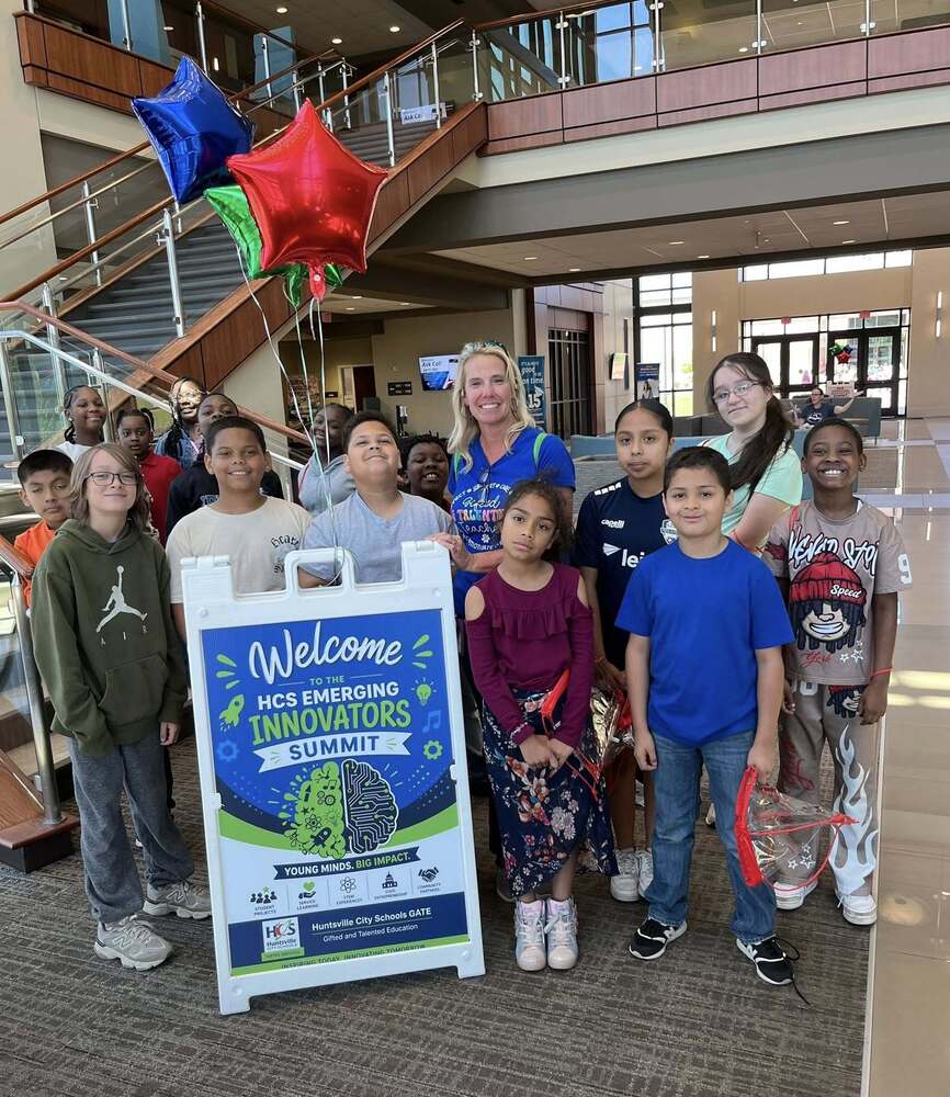 GATE students and Teacher Smile for a Photo in front of welcome sign