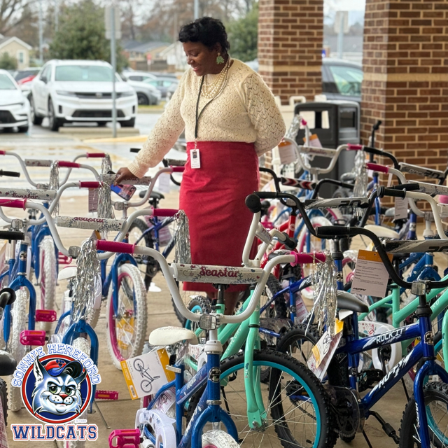Principal Tarria Walters standing in the middle of a large number of bikes